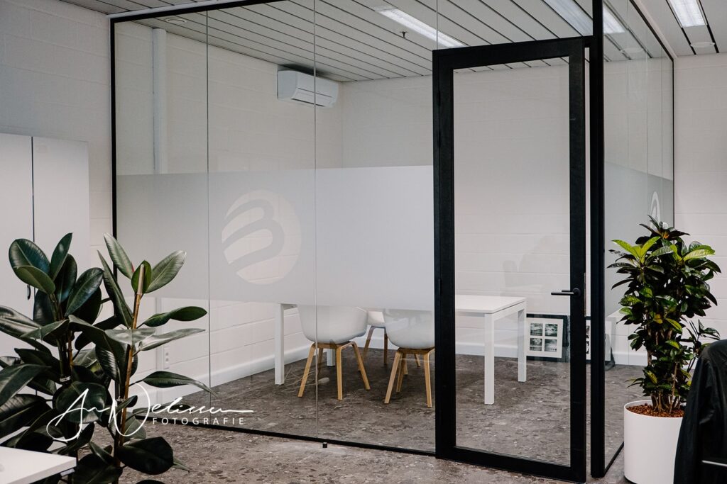 Glazen binnenwand op kantoor - kantoorindeling met glas - framed acoustic deur - akoestische glazen deur in kader met valdorpel